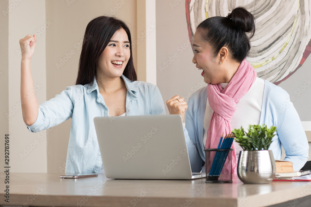 Senior woman and daughter are working at home using computers and laptops, with the internet communicating online with other people. Senior woman and daughter are working at home using computers and laptops, with the internet communicating online with other people.