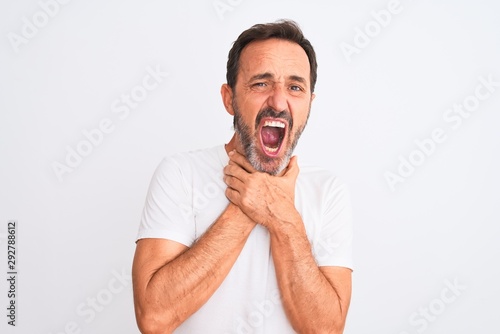 Middle age handsome man wearing casual t-shirt standing over isolated white background shouting and suffocate because painful strangle. Health problem. Asphyxiate and suicide concept.