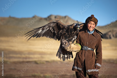Traditional kazakh eagle huntress with her golden eagle that is used to hunt for fox and rabbit fur. Ulgii, Western Mongolia.