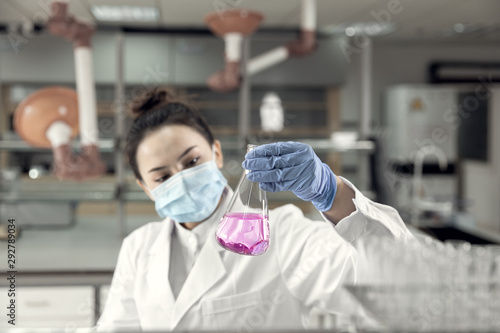 Female scientist looking at the sample in laboratory