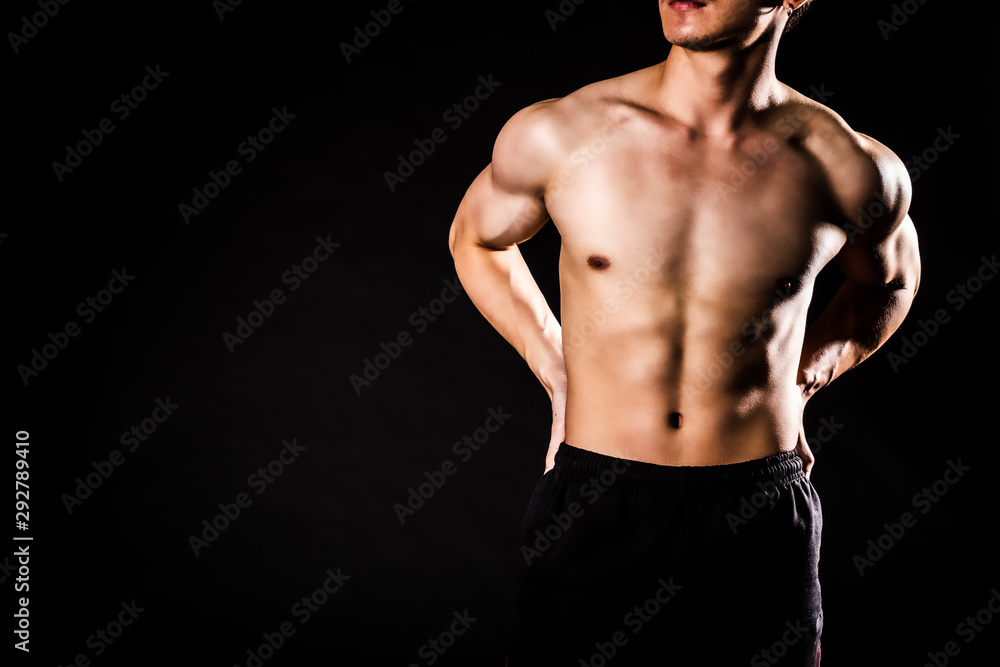 sport man standing showing muscle bodybuilding on black backgrounds, fitness concept, sport concept