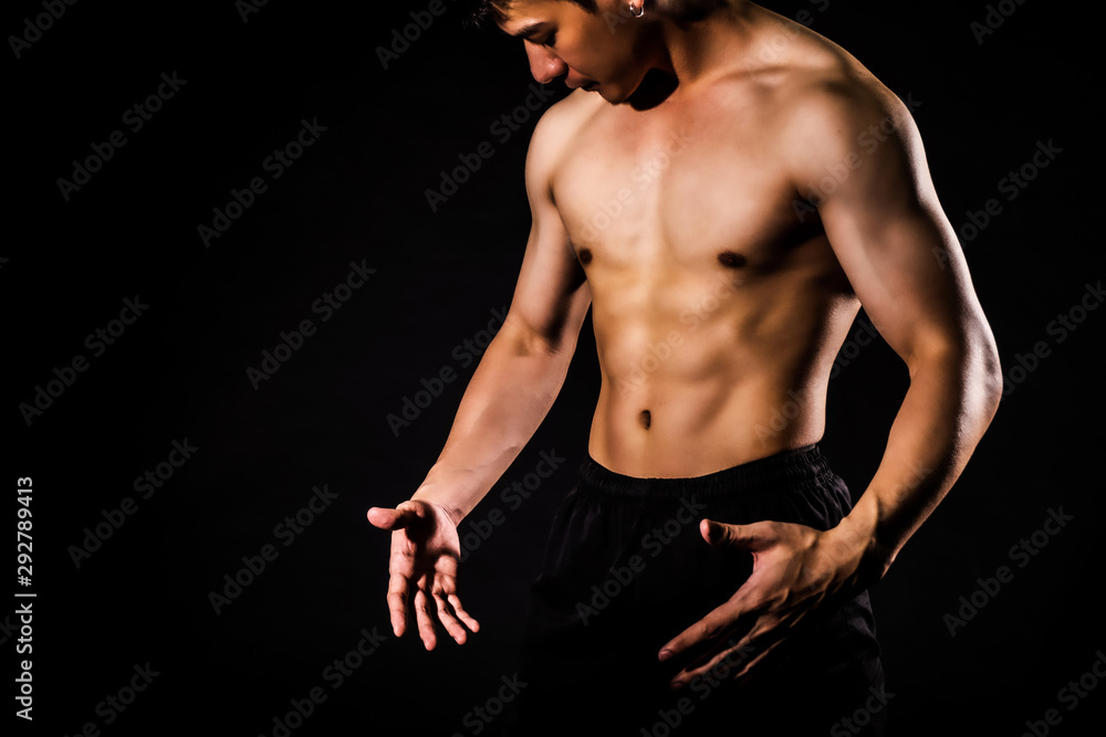 sport man standing showing muscle bodybuilding on black backgrounds, fitness concept, sport concept