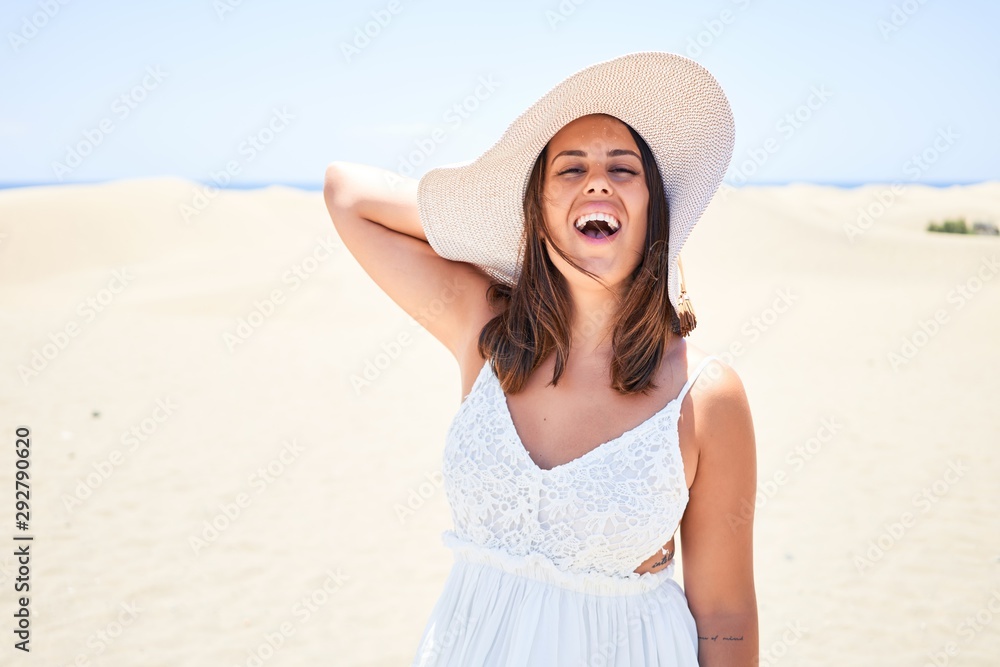 Young beautiful woman smiling happy enjoying summer vacation at maspalomas dunes beach Young beautiful woman smiling happy enjoying summer vacation at maspalomas dunes beach