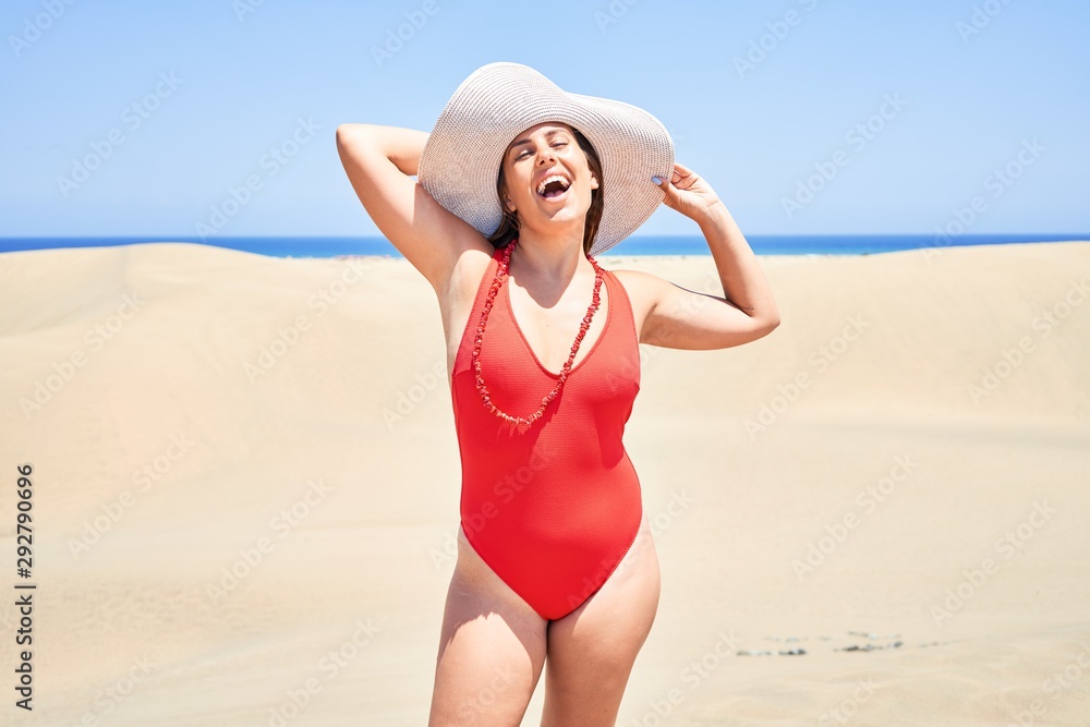 Young beautiful woman sunbathing wearing summer swinsuit at maspalomas dunes bech Young beautiful woman sunbathing wearing summer swinsuit at maspalomas dunes bech