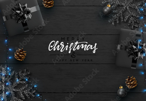 Christmas background. Wood plank texture, black snowflakes are strewn with sparkles, realistic pine cone, decorative baubles, gift boxes, xmas bright light blue garland. Merry Christmas Happy New Year