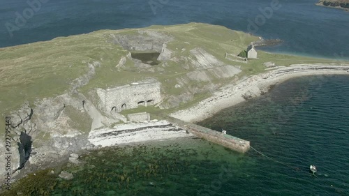 An aerial view of Ard Neakie abandoned lime kilns on a sunny summer's day. Rotating anti-clockwise around the entrance to the kilns with zoom in. photo