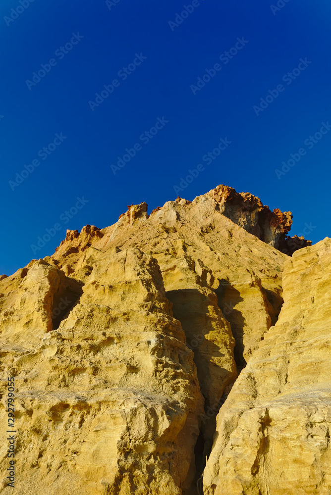 Fototapeta premium Yellow cliffs with blue sky in background
