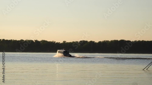 Fishing schooner at sunset, swimming fast.