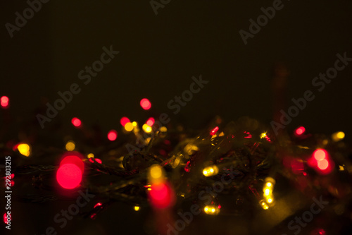 electric colored garland shine on black surface