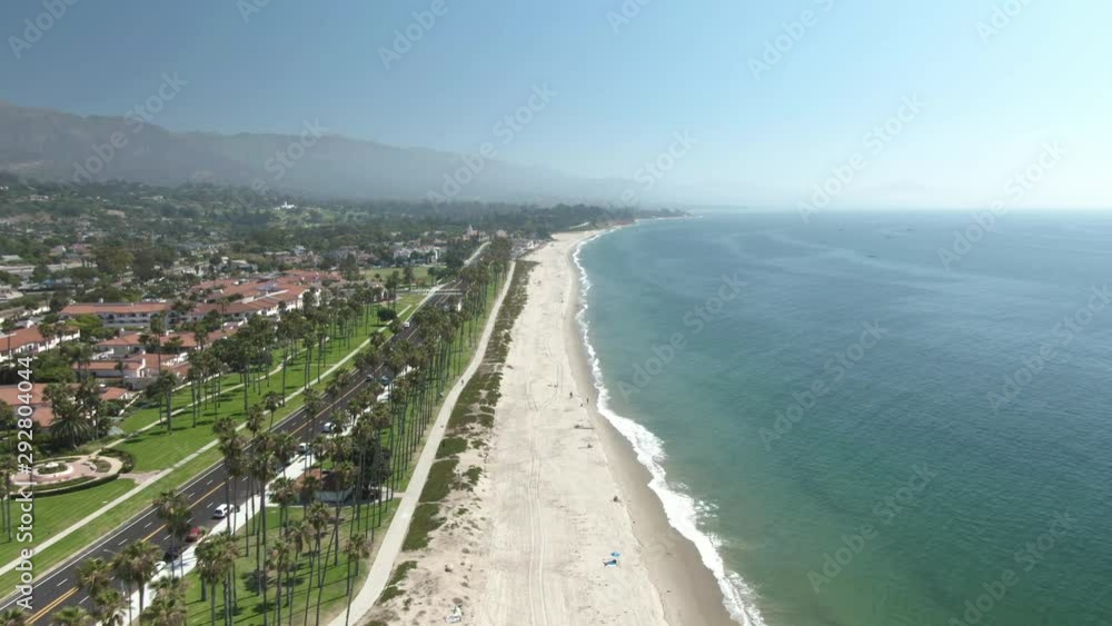 High altitude aerial of the public beach in Santa Barbara, California, USA, during a warm and sunny day. Waves of the Pacific ocean crash on the shore with the beautiful city on the left. #1 High altitude aerial of the public beach in Santa Barbara, California, USA, during a warm and sunny day. Waves of the Pacific ocean crash on the shore with the beautiful city on the left. #1