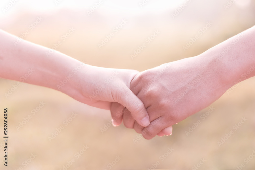 Men and women holding hands in the middle of nature in the fall Men and women holding hands in the middle of nature in the fall