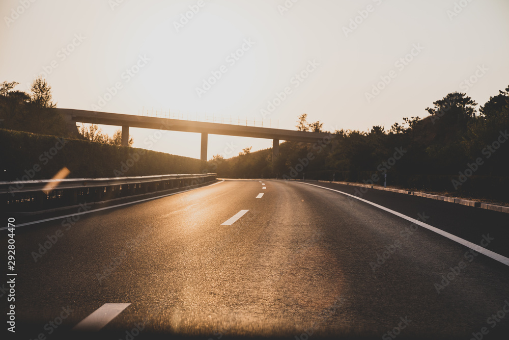 Fototapeta premium Sunset on straight country road