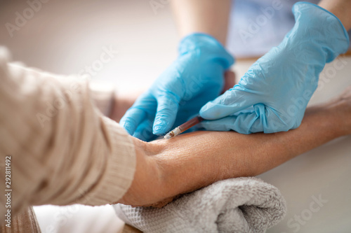 Close up of medical attendant wearing gloves making injection