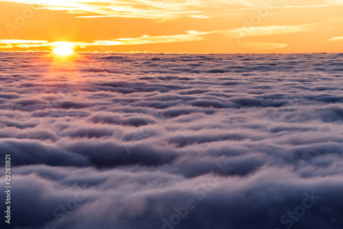 Beautiful sunset over a valley filled by fog