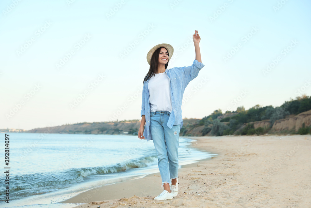 Beautiful young woman in casual outfit on beach Beautiful young woman in casual outfit on beach