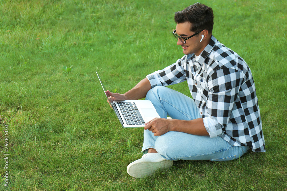 Portrait of young man with laptop outdoors Portrait of young man with laptop outdoors