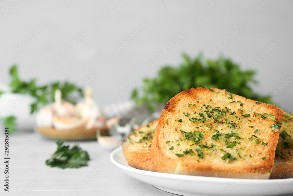 Slices of toasted bread with garlic and herbs on blue wooden table. Space for text Slices of toasted bread with garlic and herbs on blue wooden table. Space for text