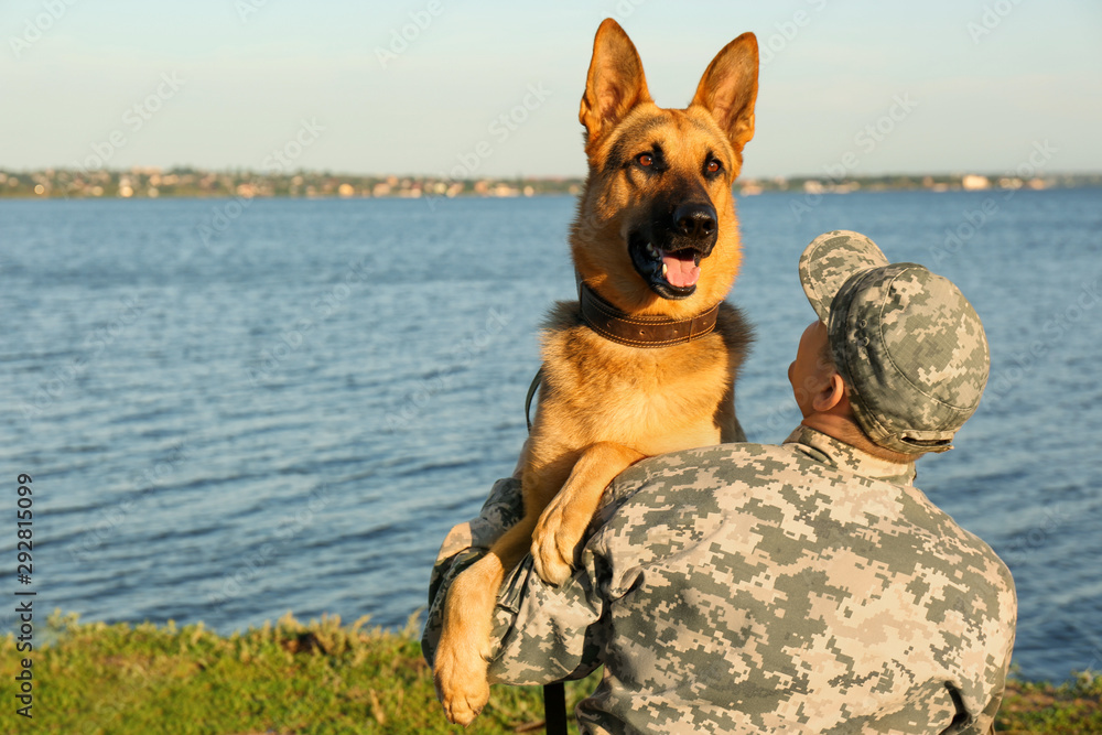 Man in military uniform with German shepherd dog outdoors Man in military uniform with German shepherd dog outdoors