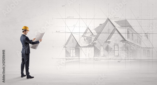Architect standing and watching an imagined house plan
