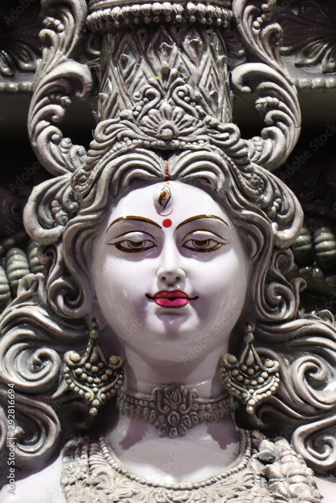 Goddess Durga idol at decorated Durga Puja pandal, shot at colored light, at Kolkata, West Bengal, India. Durga Puja is biggest religious festival of Hinduism and is now celebrated worldwide. Goddess Durga idol at decorated Durga Puja pandal, shot at colored light, at Kolkata, West Bengal, India. Durga Puja is biggest religious festival of Hinduism and is now celebrated worldwide.