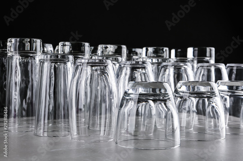 Empty glasses on marble table against black background
