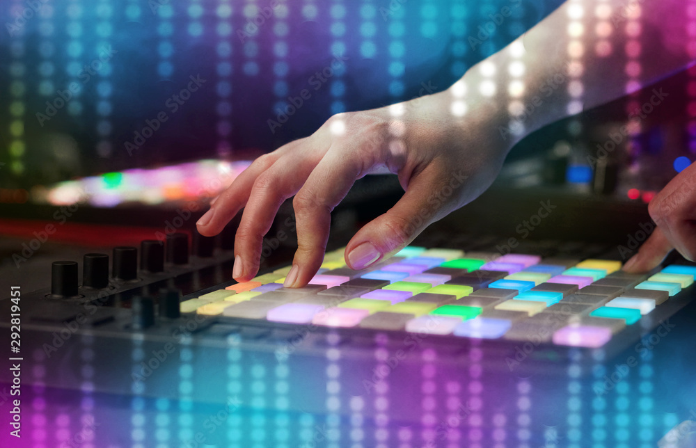 Fototapeta premium Hand mixing music on dj controller with social media concept icons