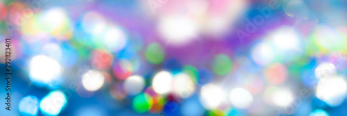 Blue colorful bokeh background wide banner. Christmas invitation or phone wallpaper