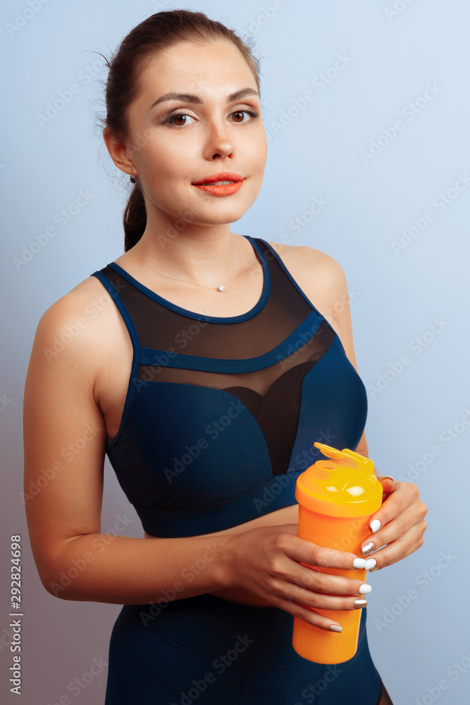 Fit sporty woman holding mineral water bottle in her hand
