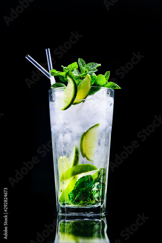 classic mojito cocktail with reflection on a dark background