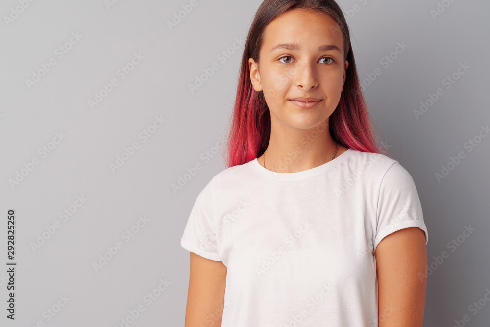 Young girl teenager with pink hair happy and smiling over gray background Young girl teenager with pink hair happy and smiling over gray background