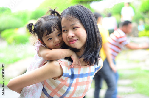 Little Child Girl and Mother at The Public Park