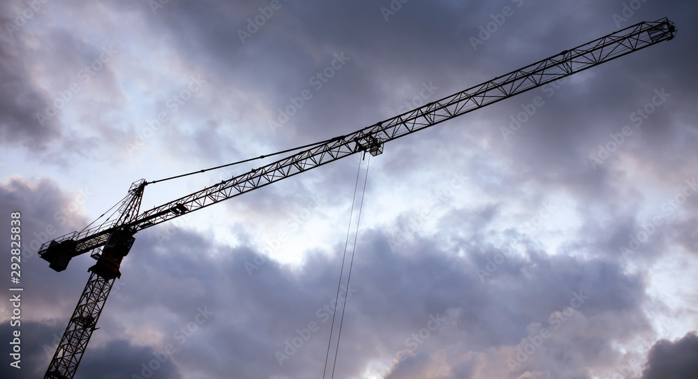 Tower crane on a background of thunderclouds Tower crane on a background of thunderclouds
