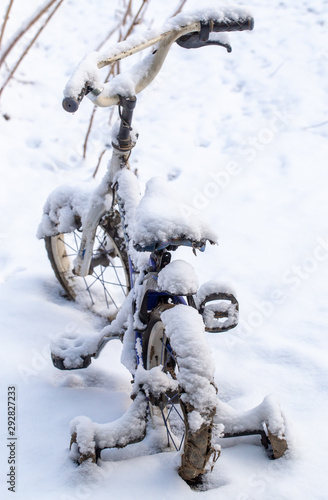 The bike is covered with snow in the winter