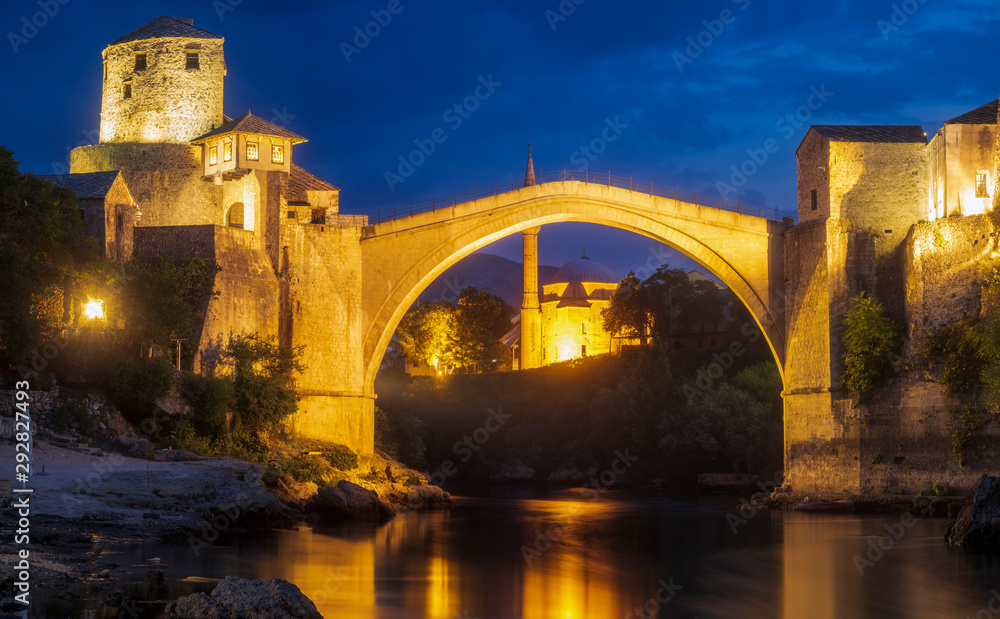 Old bridge and panorama of Mostar by night