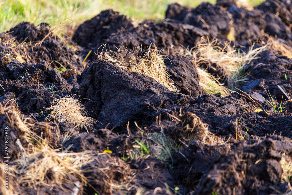 Plowed black soil on nature as a background Plowed black soil on nature as a background