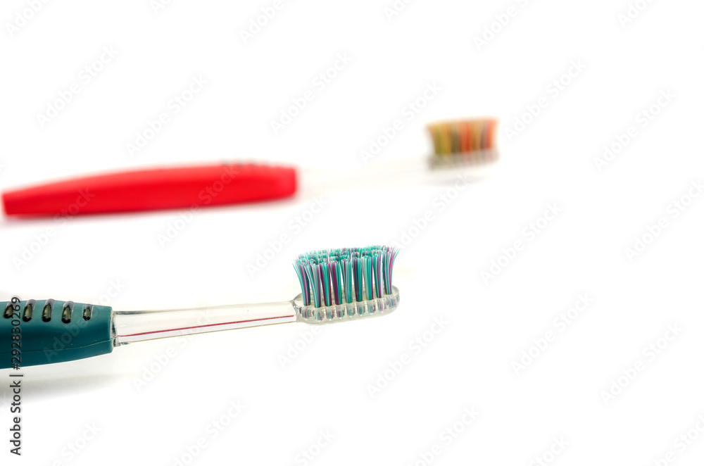 green and red toothbrushes isolated on a white background.