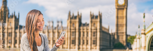Canvas Print Phone london Asian young woman using cellphone texting on online app on Europe travel city lifestyle banner panorama background
