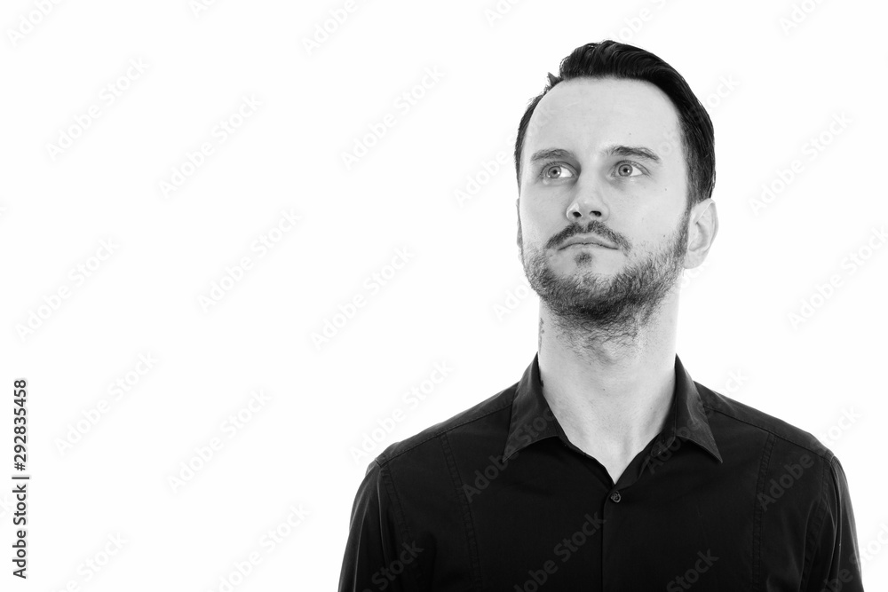 Studio shot of young man thinking while looking up Studio shot of young man thinking while looking up