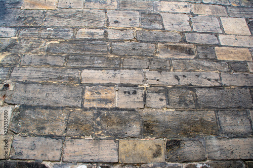 Background with a wall of old masonry with blackened stones