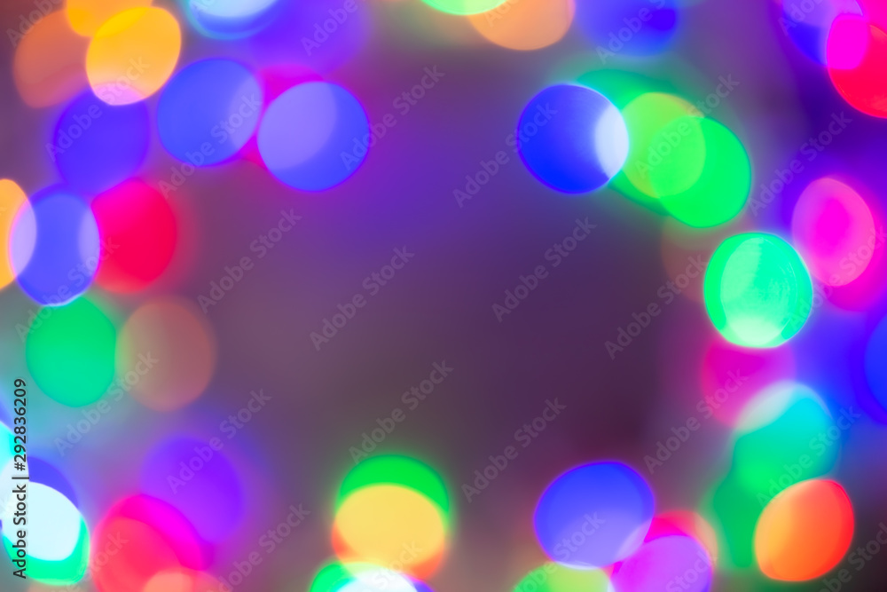 Blurred and defocused abstract multicolor background with christmas lights, soft multicolored bokeh circles