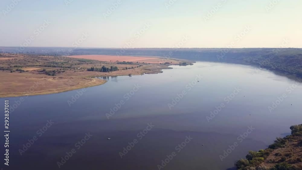 Top view of Dnestr (Dniester) river in autumn. River surrounds yellow field and green forest. Moldova republic of. Top view of Dnestr (Dniester) river in autumn. River surrounds yellow field and green forest. Moldova republic of.
