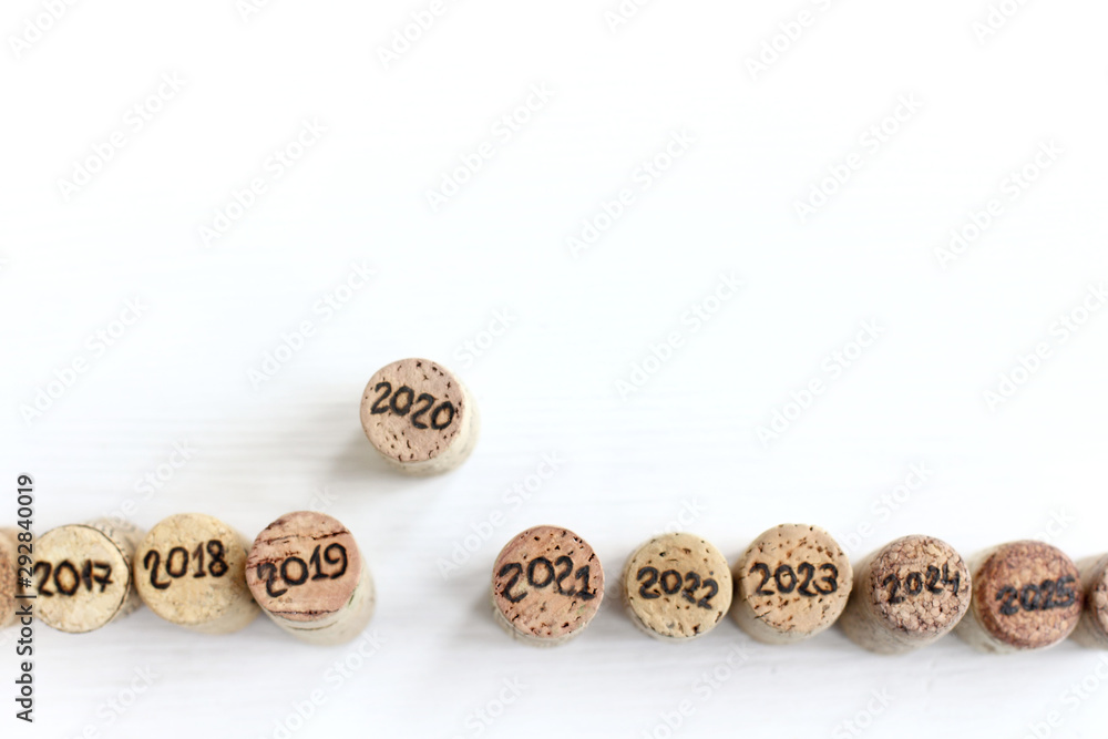 wine cork with the number 2020 pushed ahead of other corks with other numbers top view. upcoming new year wine cork with the number 2020 pushed ahead of other corks with other numbers top view. upcoming new year