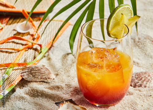 Glass of orange and rum blend cocktail with ice photo