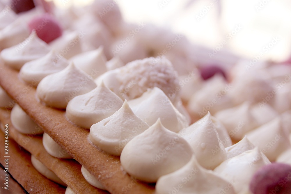 white air whipped cream on a puff cake of thick honey cakes, homemade dessert concept, close-up white air whipped cream on a puff cake of thick honey cakes, homemade dessert concept, close-up