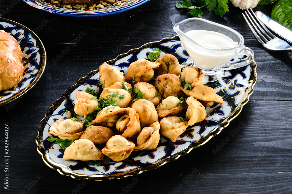 Oriental Fried duchansky chuchvara Dumplings with Minced Meat also known as Gyoza. Close Up. Hot Crunchy Deep-Fried Beef and Mutton Pelmeni Oriental Fried duchansky chuchvara Dumplings with Minced Meat also known as Gyoza. Close Up. Hot Crunchy Deep-Fried Beef and Mutton Pelmeni