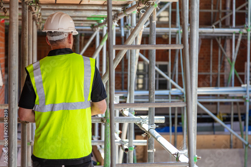 Photos Rear View of a Construction Worker, Builder or Architect on Building Site