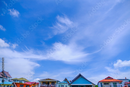 village against sky clouds, blue fluffy clean, bright weather light summer