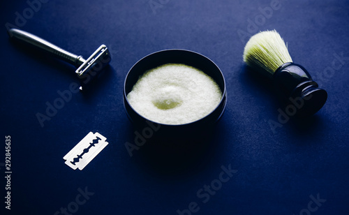 Shaving brush  razor and blade on the blue table. Stylish men set. idea for a gift. Barber shop things.