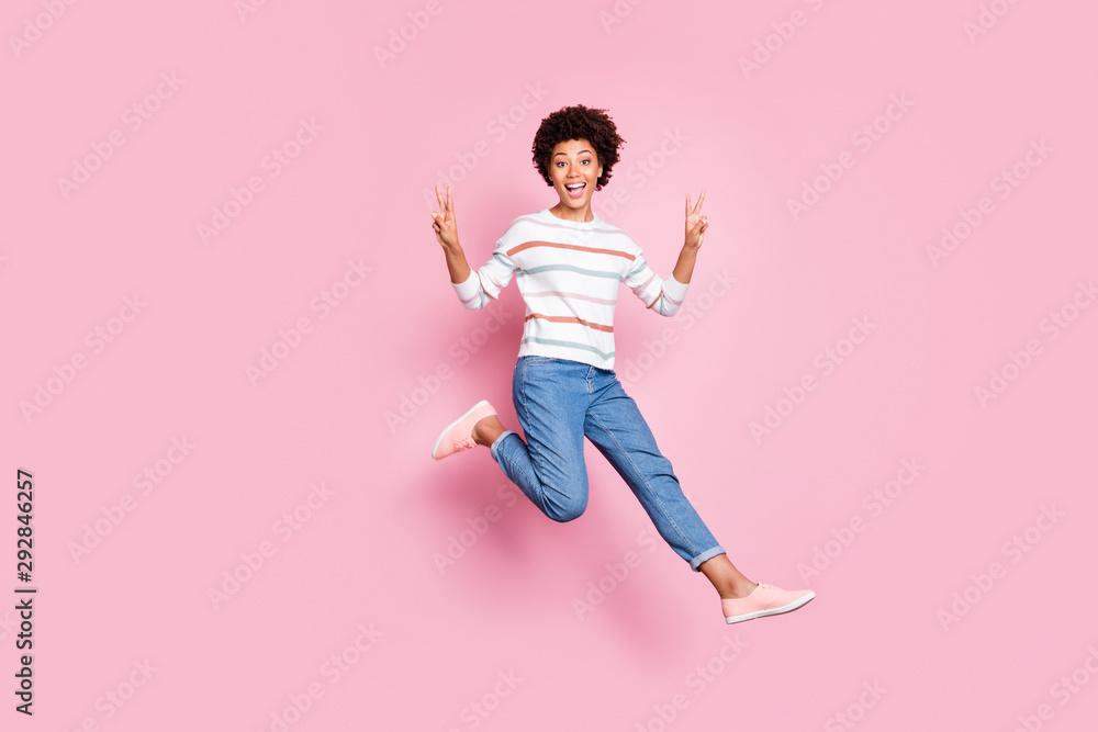 Full length body size photo of cheerful cute funny girl showing you double v-sign while running towards goods discounted at shopping mall in jeans denim striped sweater isolated pastel color