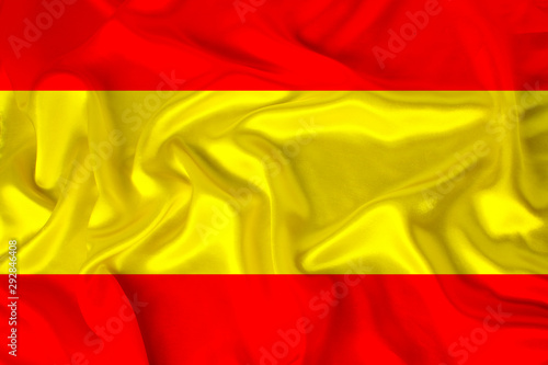 photo of the national flag of the state of Spain on a luxurious texture of satin  silk with waves  folds and highlights  closeup  copy space  illustration
